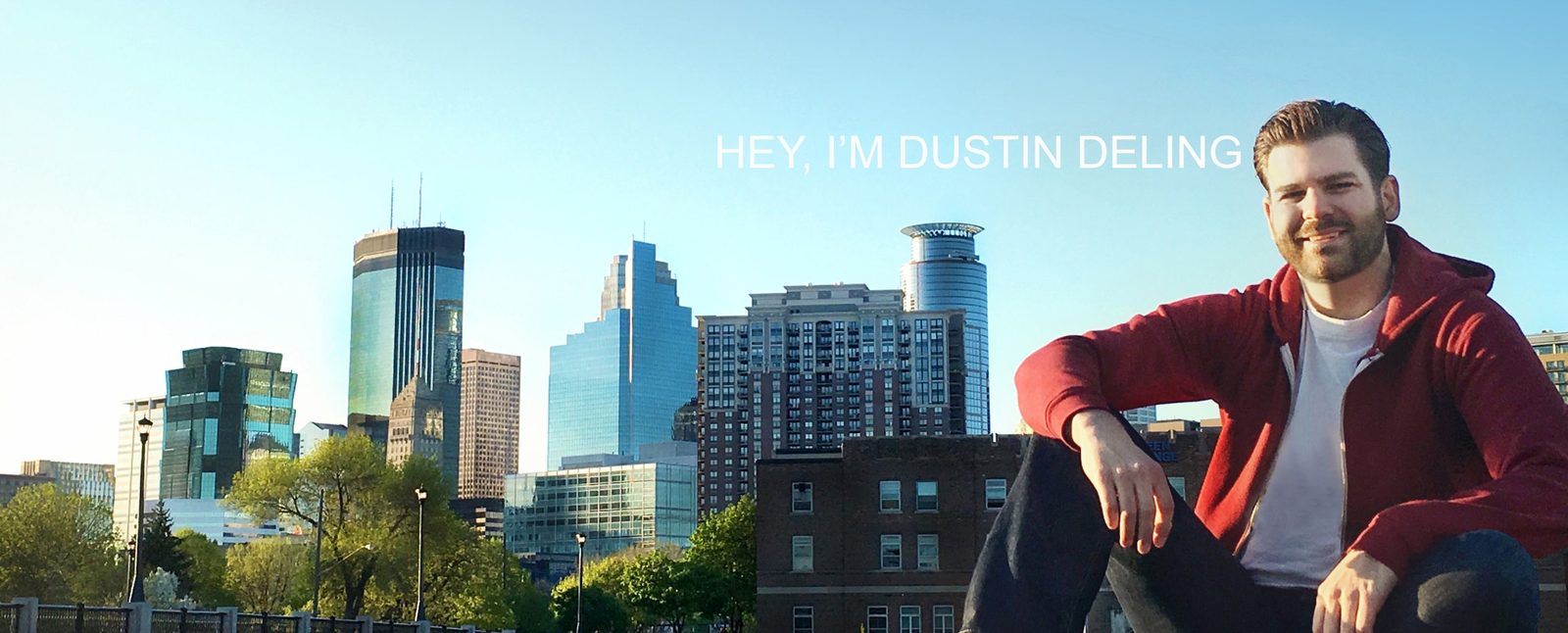 Dustin Deling smiling in front of the Minneapolis skyline